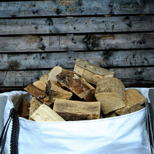 Firewood in a white bag with a wooden background
