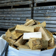 kiln dried ash Firewood stacked in a white bag with wooden crates labeled 'Black Country Firewood' in the background.