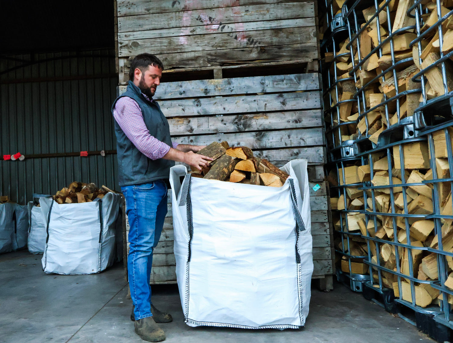 Richard stood next to a bulk bag of logs