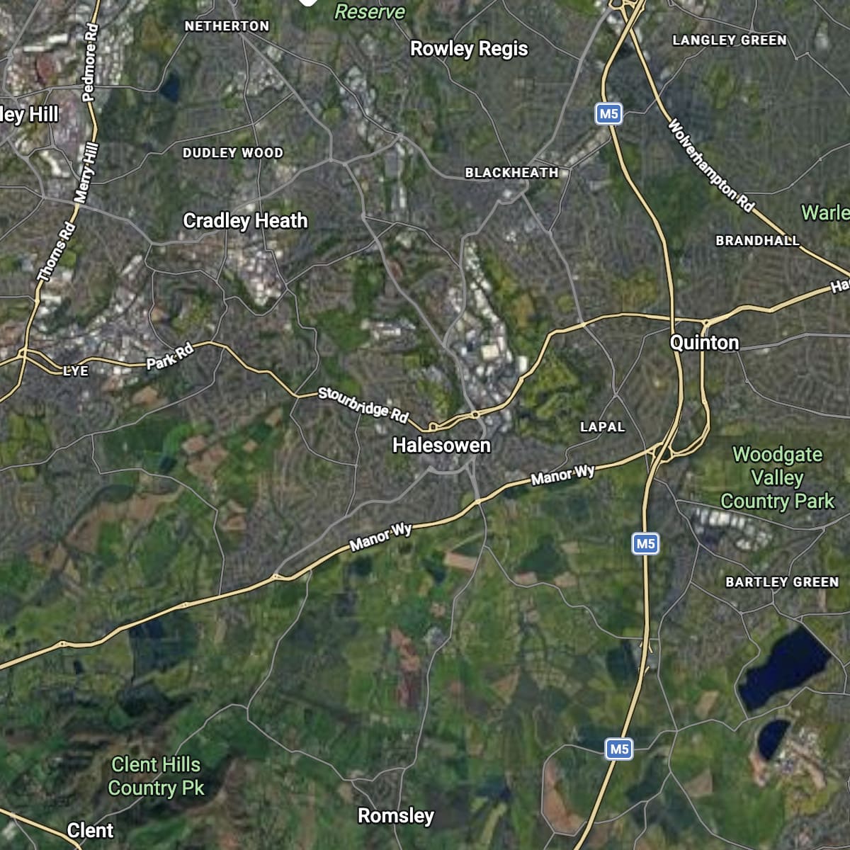 A satellite map view of Halesowen and surrounding areas including Rowley Regis, Quinton, Cradley Heath, and Woodgate Valley Country Park, with roads, labels, and green land coverage. This is the area black country firewood delivery their logs for sale
