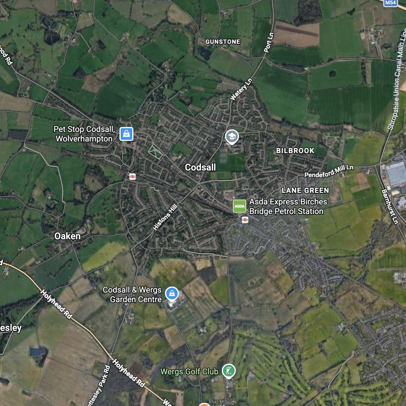 Aerial satellite map view of Codsall, showing the town center, surrounding green fields, roads, and nearby landmarks including a petrol station, garden centre, and golf club. where black country firewood delivery logs for sale