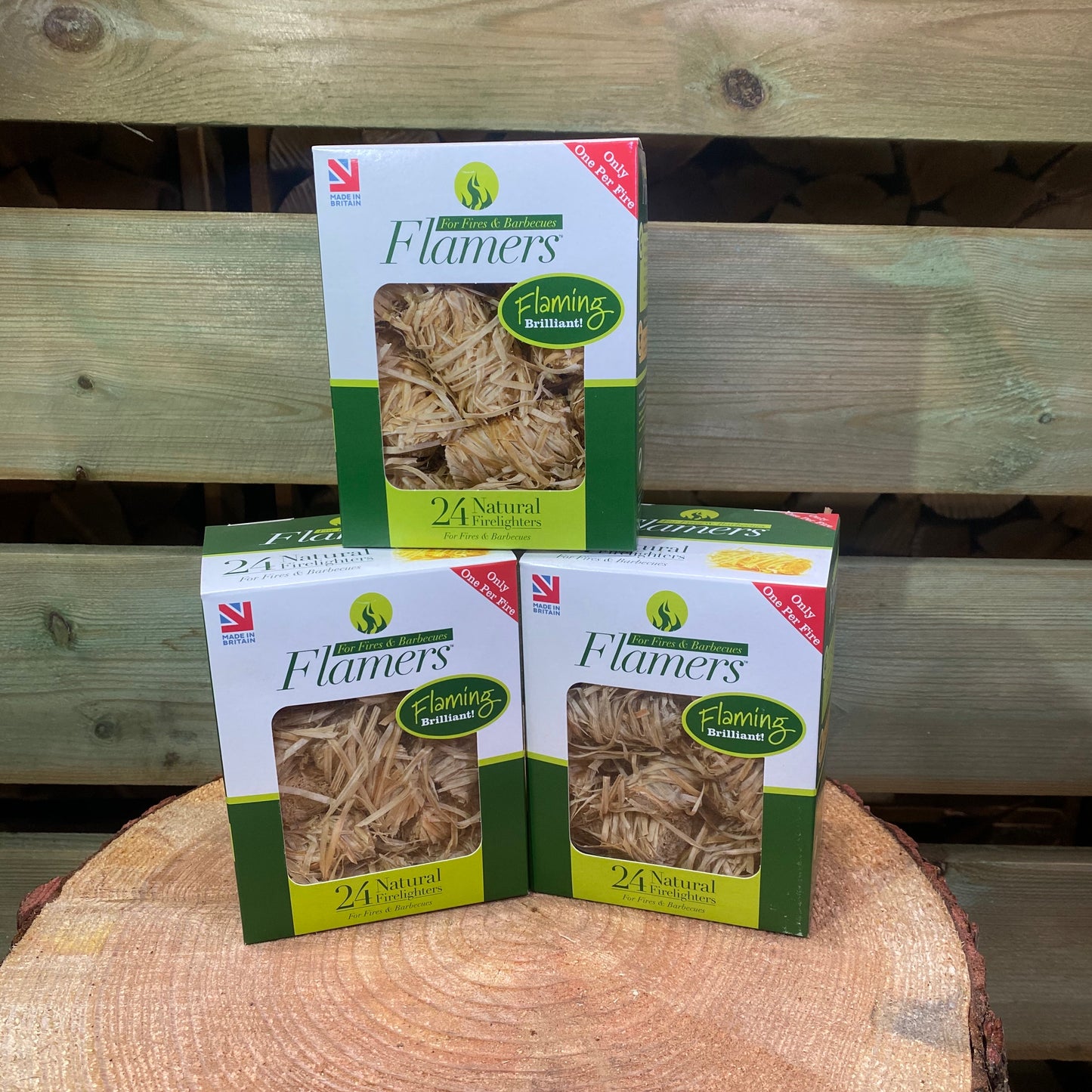 3 boxes of 24 pack Flamers Firelighters stacked on a chopping block