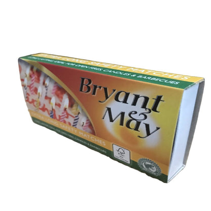 A pack of Bryant & May safety matches, with a green and yellow label, placed on a wooden surface.