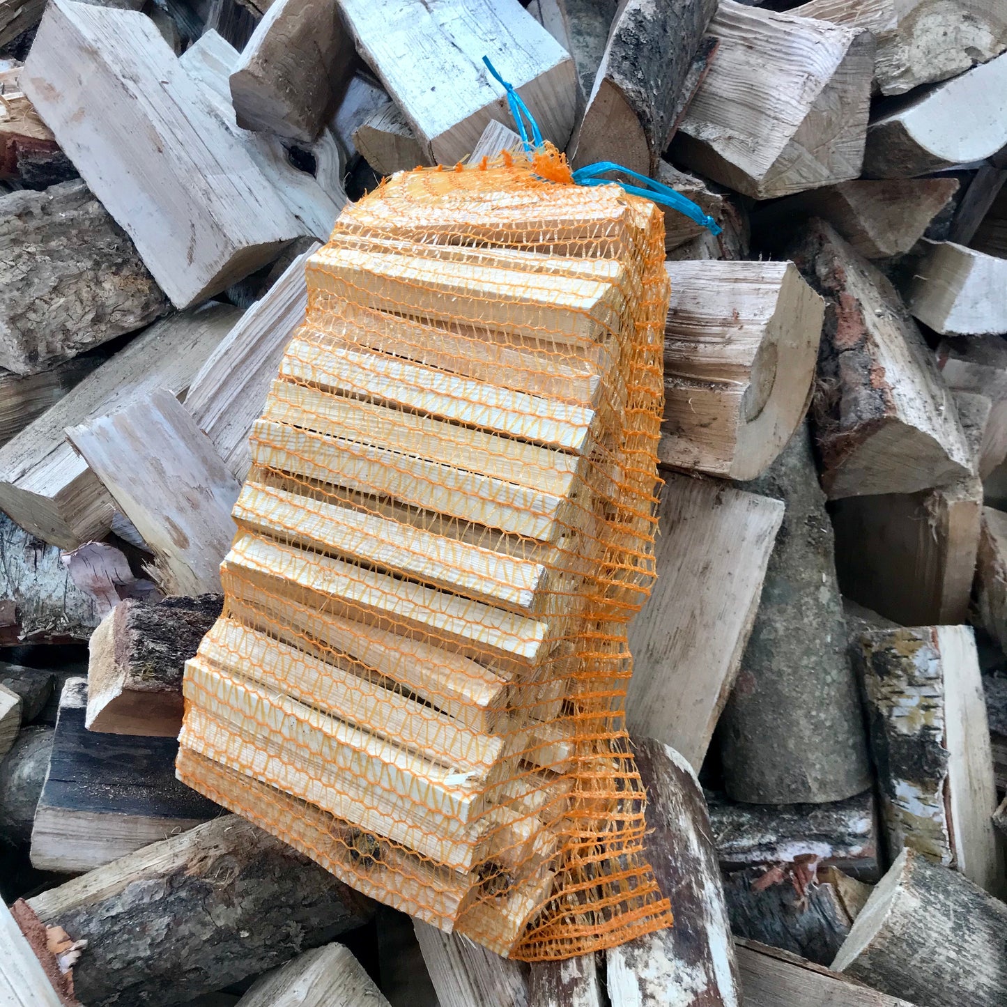 Net of kindling with log background