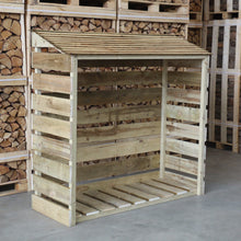 A standard size wooden log store with a slanted roof, constructed from light colored wood, placed in a storage area with other wooden materials in the background.